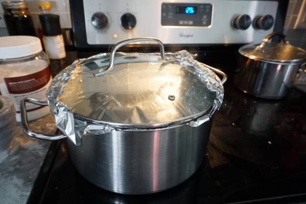 Pot with foil seal and a lid for cooking rice 