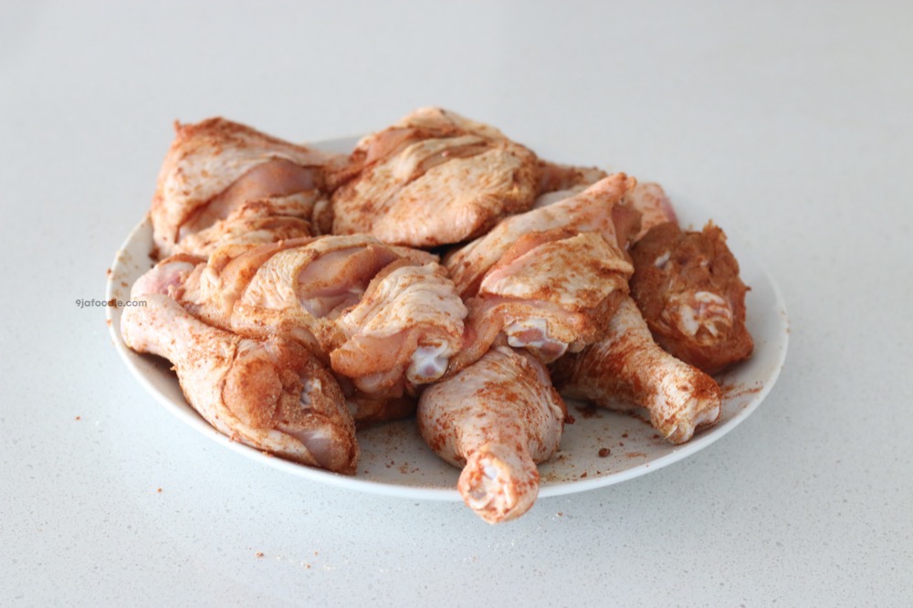 Raw chicken covered in spices - chicken breast and drumsticks